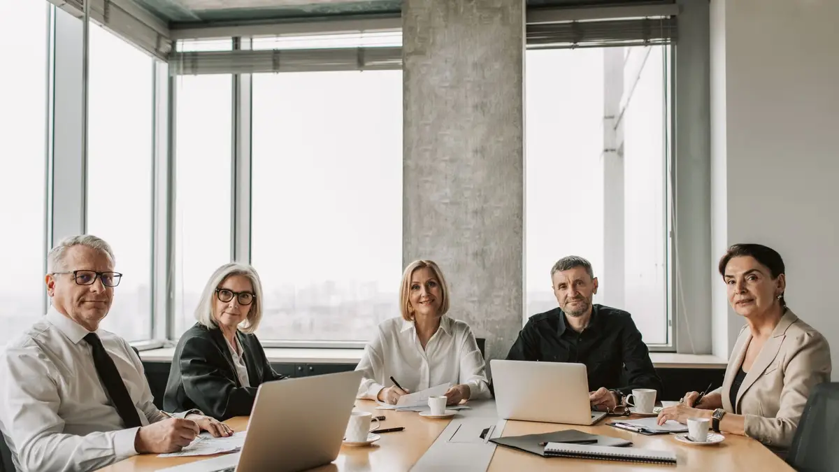Older employee in a meeting with colleagues at work