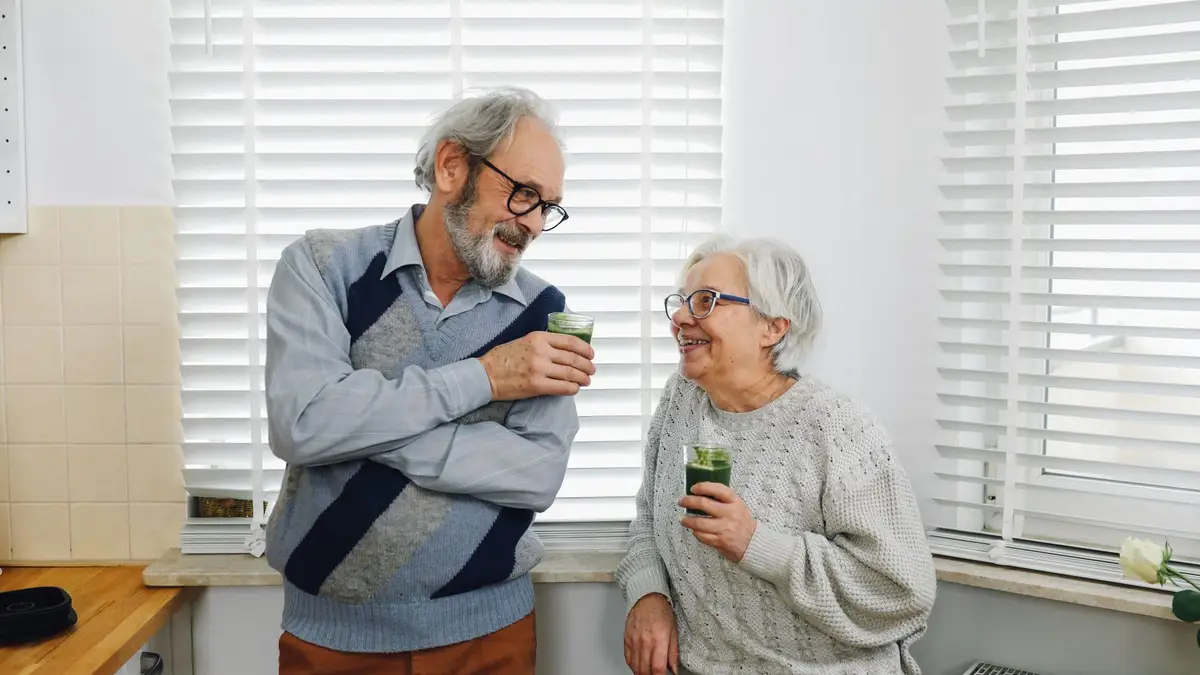 Senior couple comparing insurance papers together at home