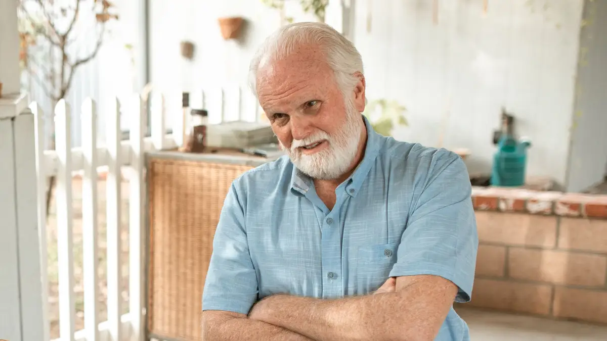 Man in his sixties smiling at home