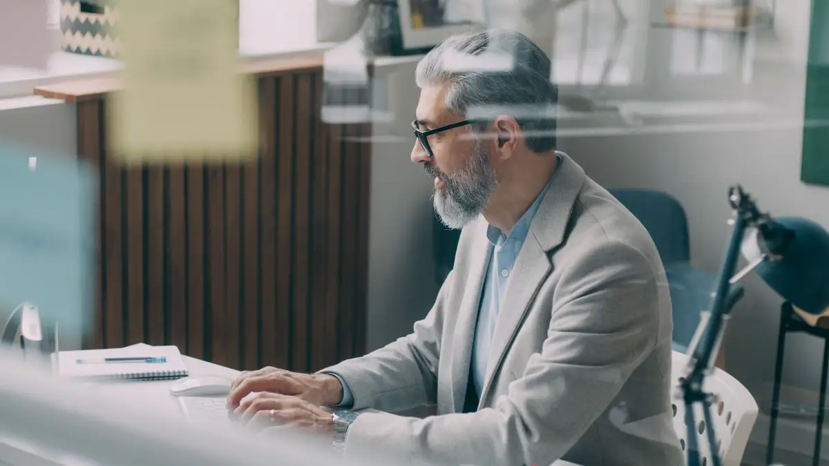 Mature businessman checking his calendar at his desk