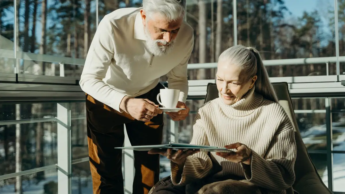 Retired couple having coffee in the garden