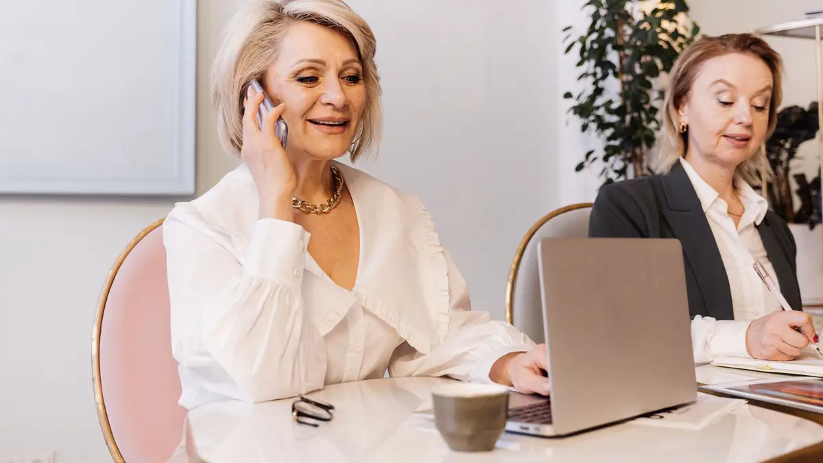 Woman in her fifties working on a laptop in an office