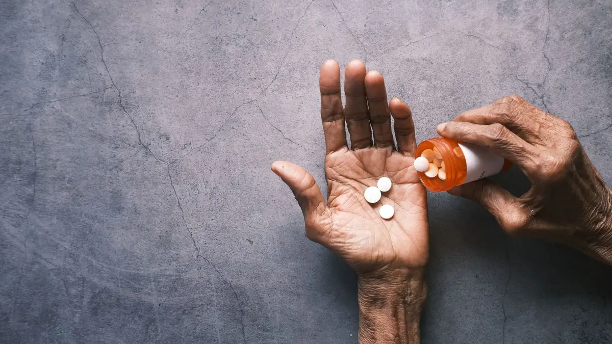 Senior hands holding a prescription pill bottle