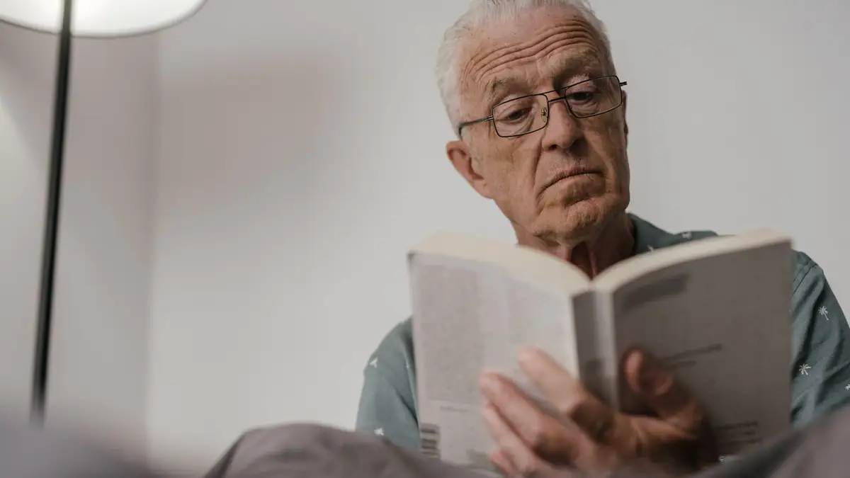 Older man wearing glasses reading a statement