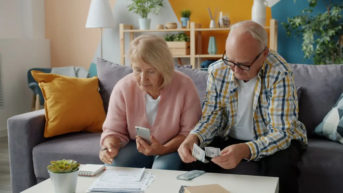 Retired couple going over their budget on a spreadsheet