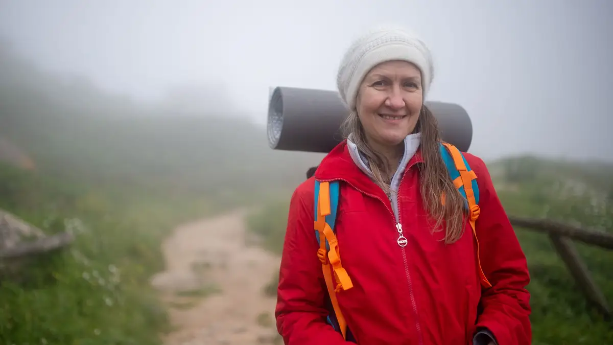Older woman hiking on a mountain trail
