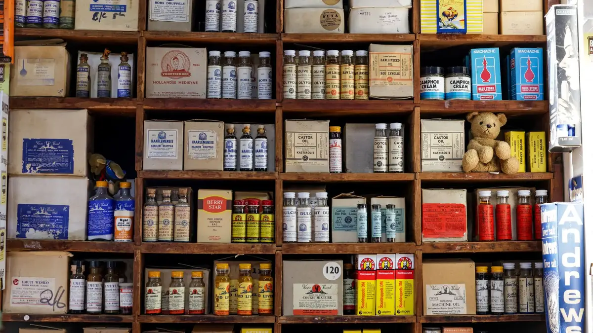 Pharmacy shelves stocked with medicine boxes
