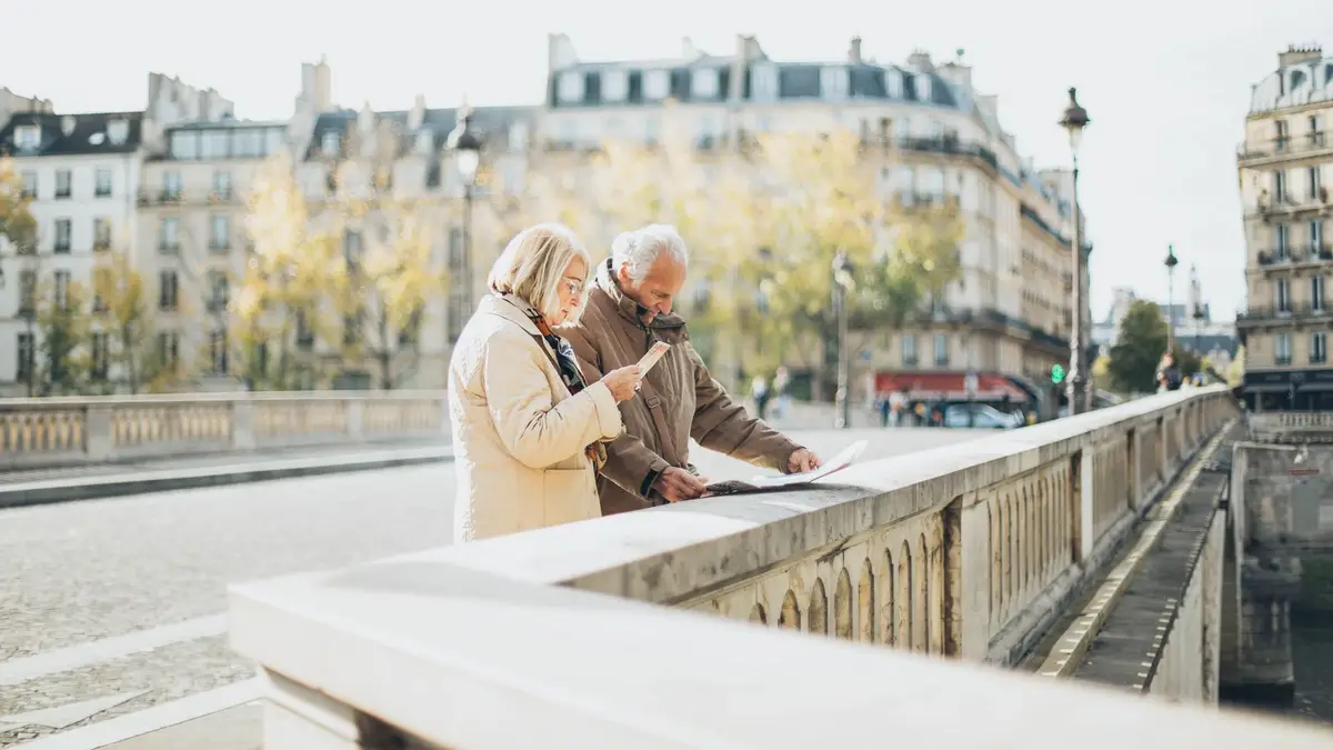 Older couple planning a trip with a map