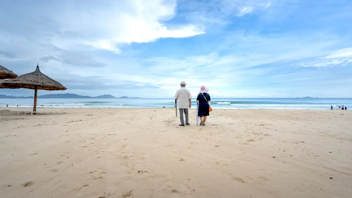 Retired couple walking on the beach