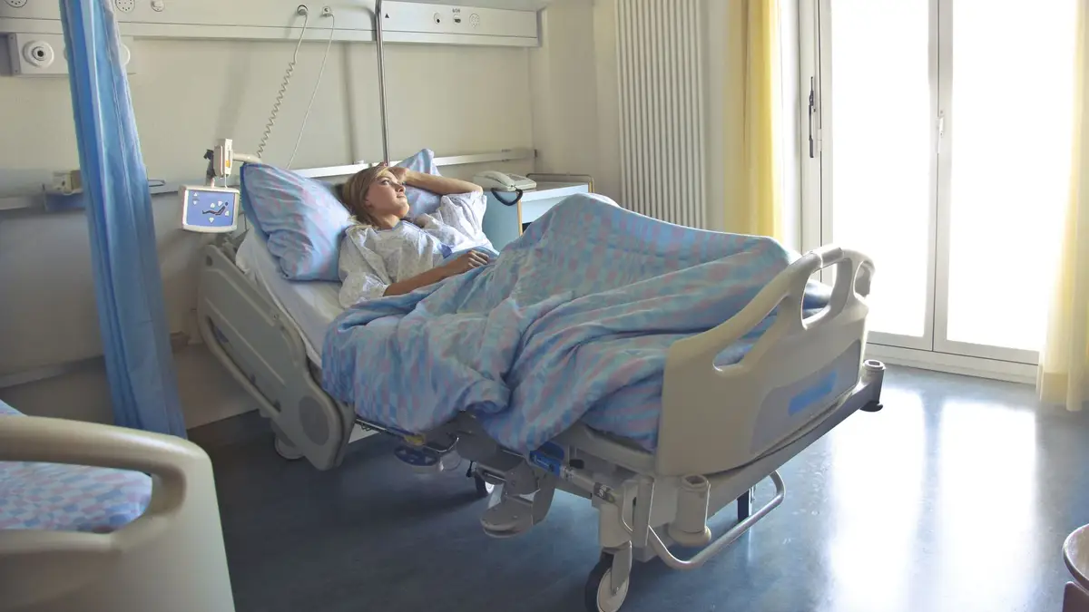 Hospital room with a bed by a sunny window