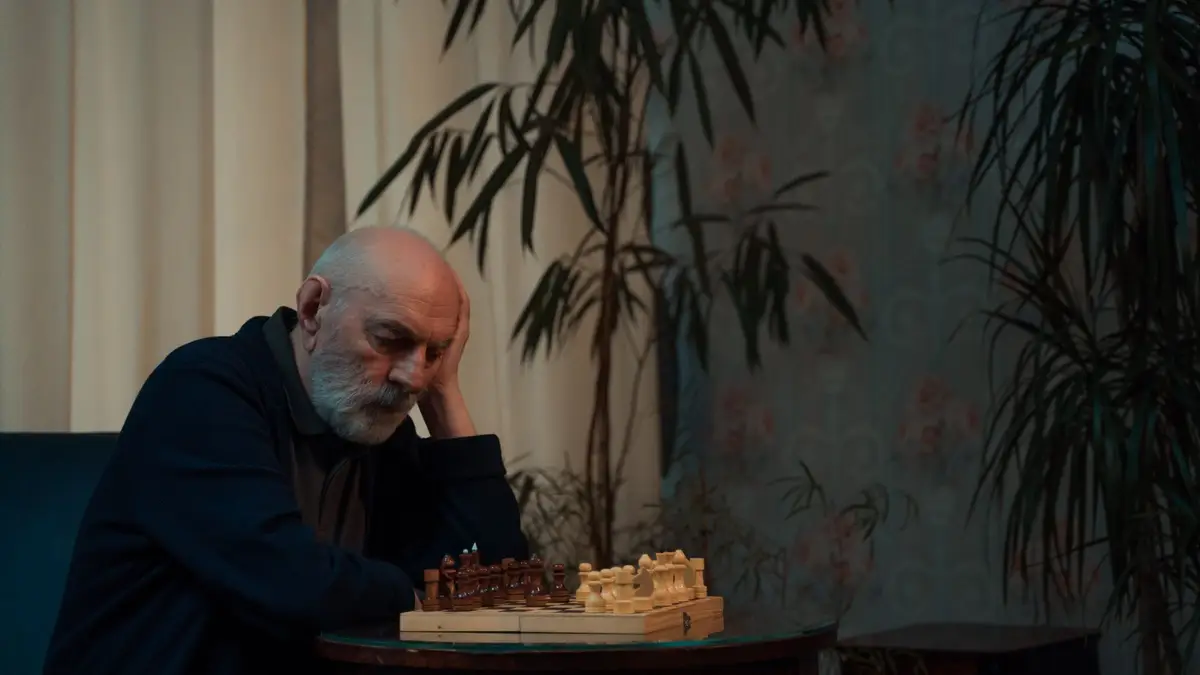 Senior man thinking over a game of chess