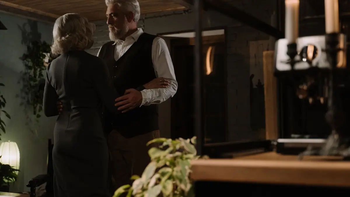 Elderly couple dancing together in their kitchen