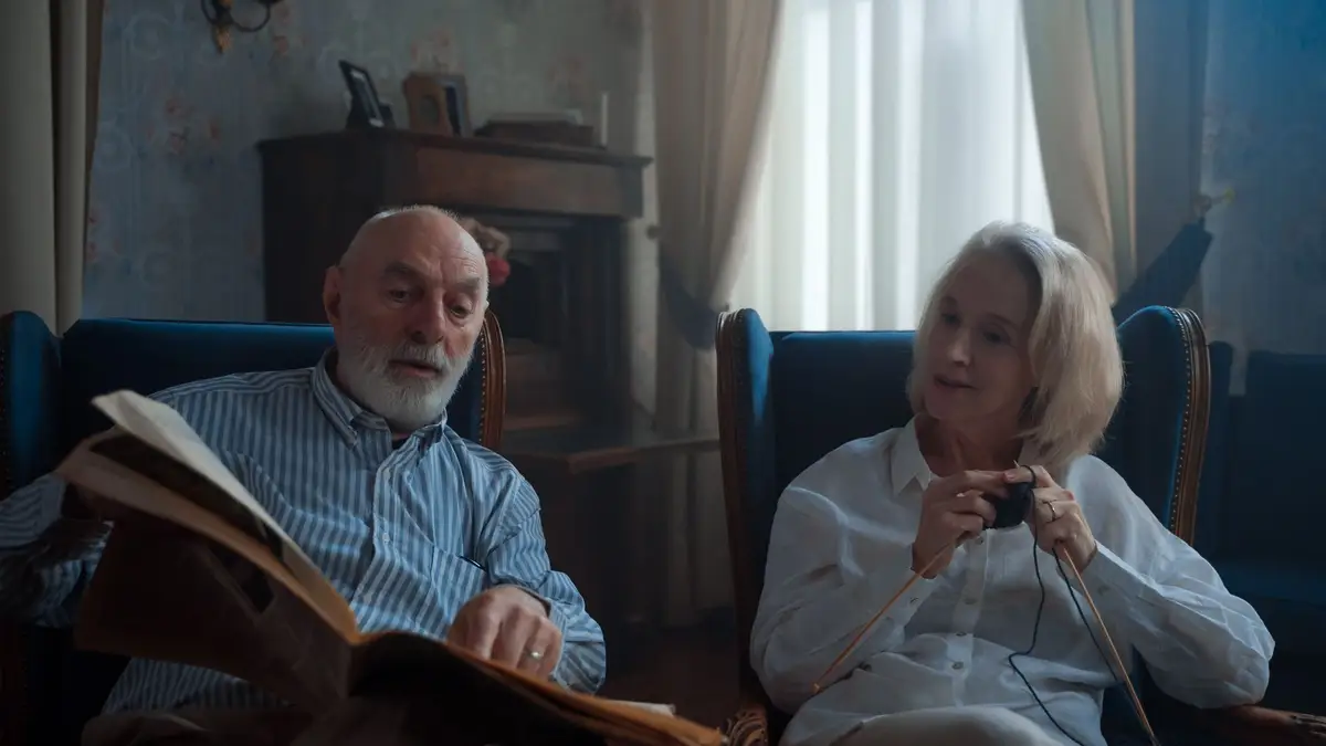 Older couple reading together in their living room
