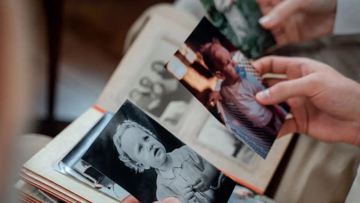Widow holding a framed photo of memories