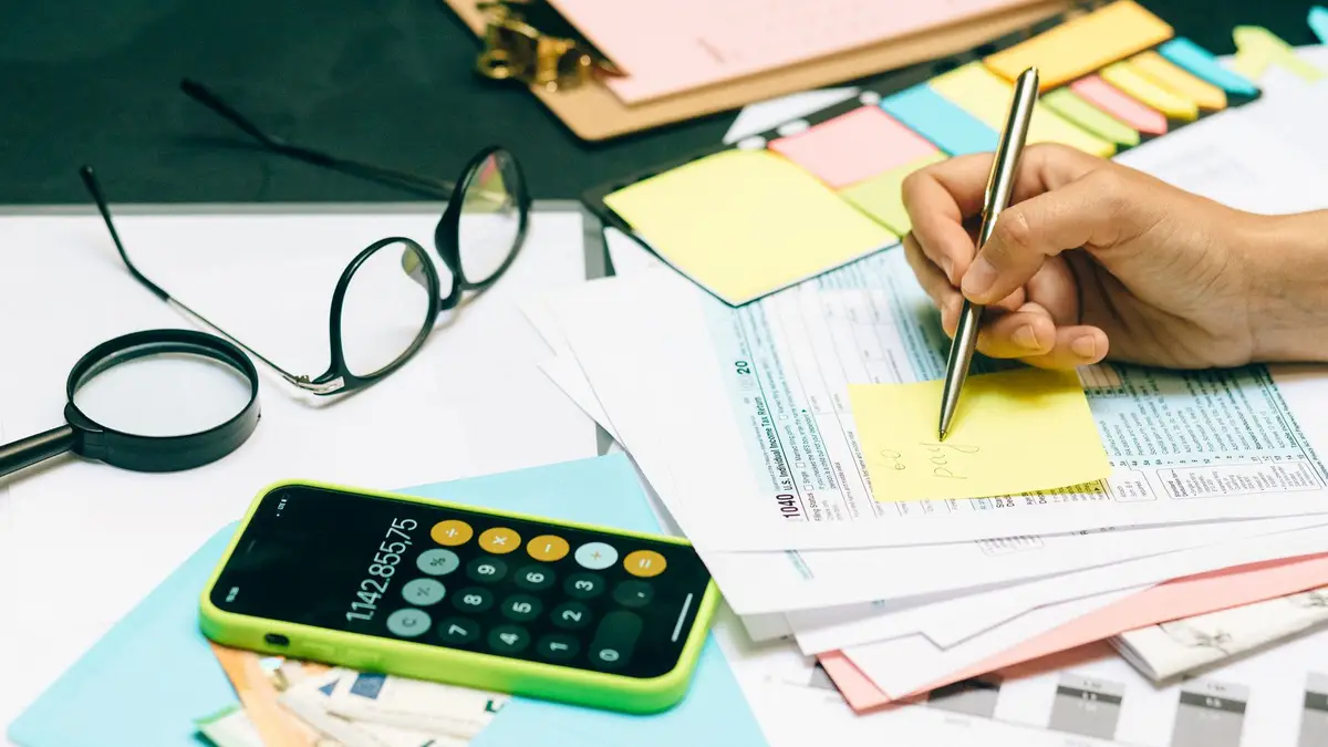 Calculator, glasses and money on a desk