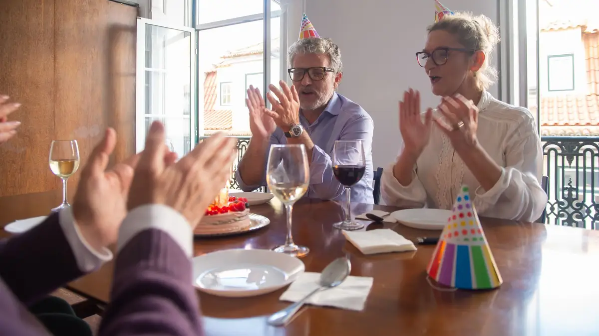Senior man celebrating his birthday at a family dinner