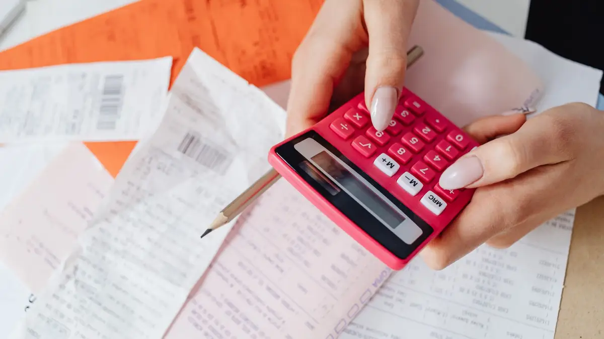 Tax documents, receipts and a calculator on a desk