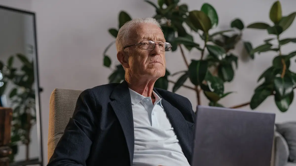 Retired man working at his home office desk