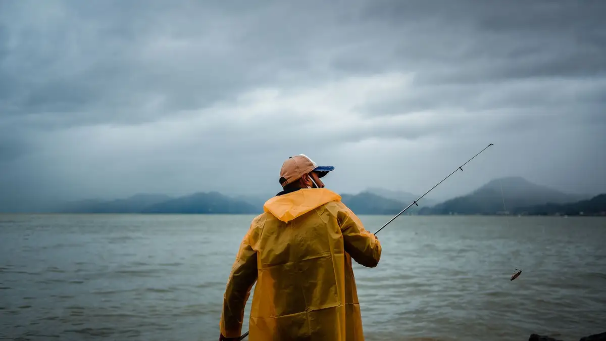 Man in his fifties fishing on a calm lake