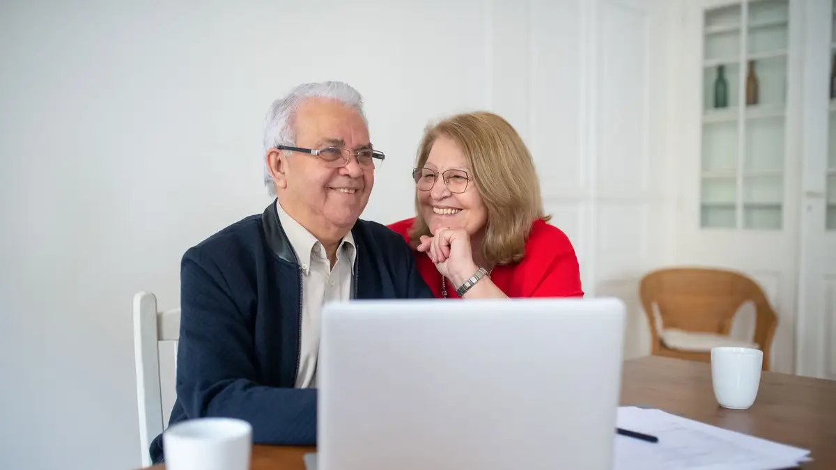 Senior couple doing their taxes on a laptop