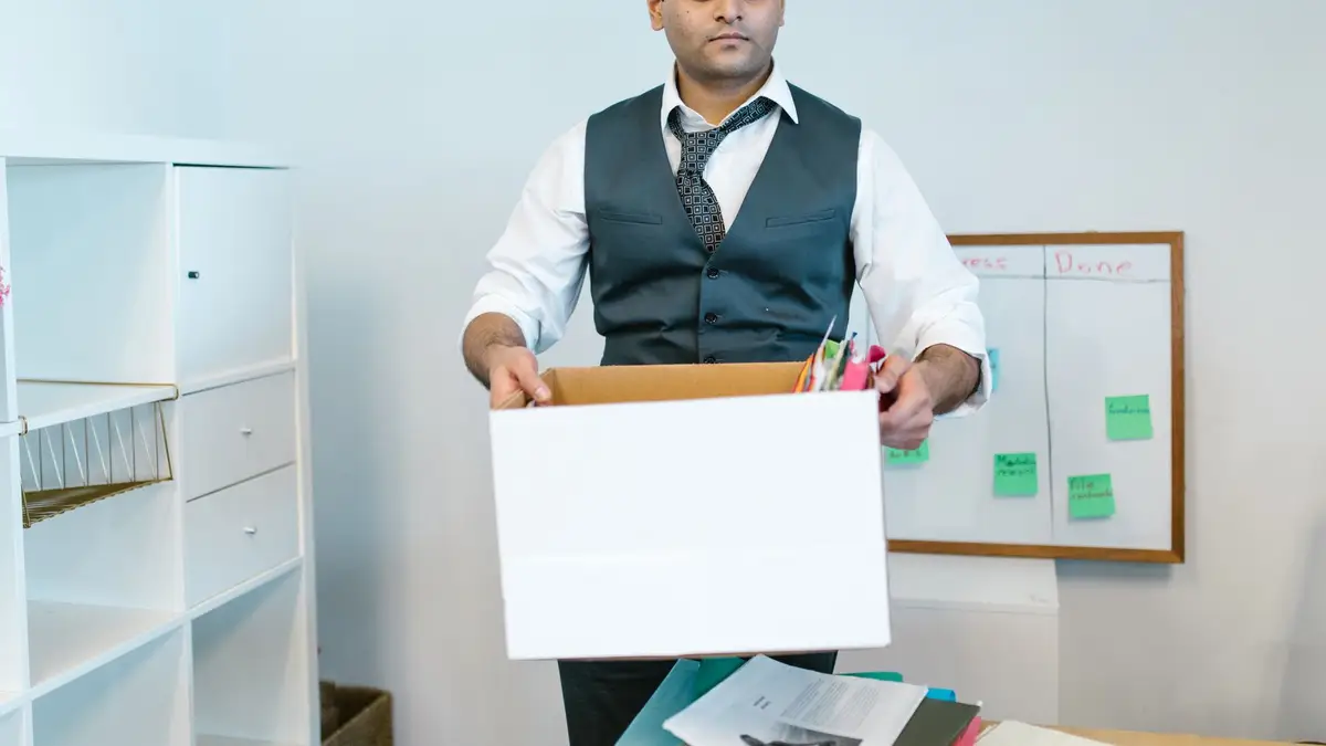 Senior man packing up his office on his last day of work
