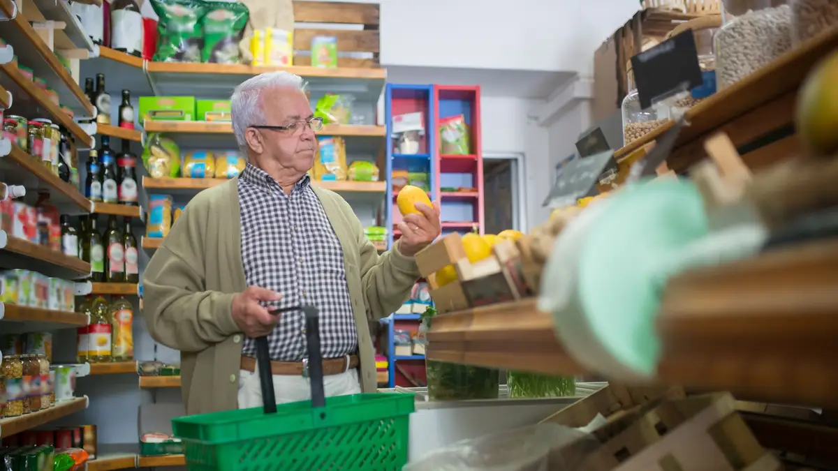 Elderly man shopping for groceries