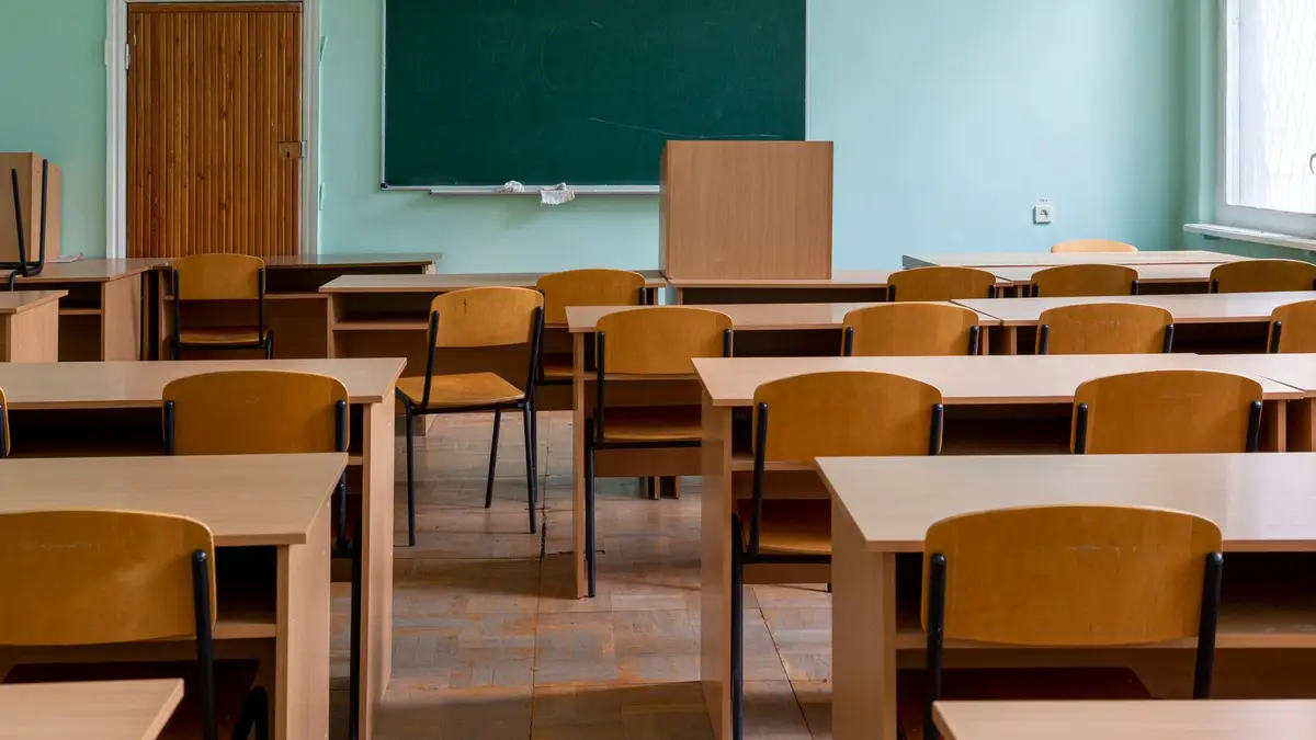 Empty classroom with desks and a chalkboard