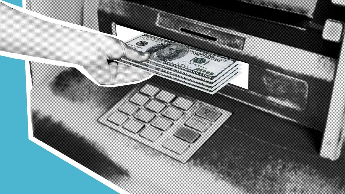 Hand withdrawing cash from an ATM